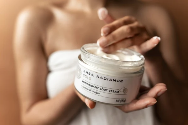 Hands holding Shea Radiance Antioxidant Body Cream